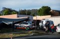 A car port collapsed and a police car was rammed at a home in Kambah.