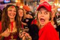 A Democrat wearing a 'Make America Great Again' hat and her friend dressed as Wonder Woman were celebating when Hillary ...
