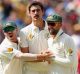 David Warner, Mitchell Starc and Nathan Lyon celebrate a wicket.