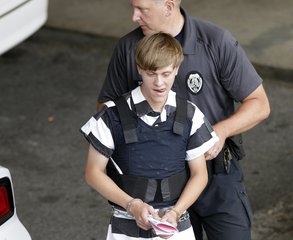 Charleston, S.C., shooting suspect Dylann Storm Roof is escorted from the Cleveland County Courthouse in Shelby, N.C., Thursday, June 18, 2015.