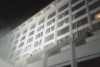 Guests scale building to flee deadly fire in Karachi hotel.