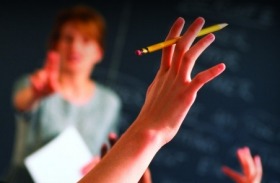 Teacher pointing to raised hands in classroom boarding school

Generic