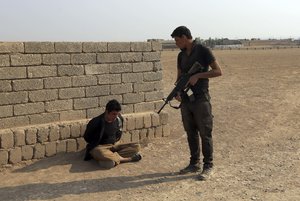 File - A member of Iraq's elite counterterrorism forces arrests a suspect of Islamic State in the village of Tob Zawa, about 9 kilometers (5½ miles) from Mosul, Iraq, Tuesday, Oct. 25, 2016.