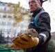 A Paris city employee shows a dead rat.