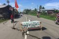 A table and flag warn motorists of cracks in the road in Trienggadang, Aceh.