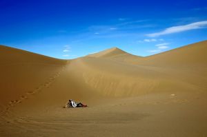 An Iranian woman relaxes on the sands while enjoying her weekend in the Mesr desert about 305 miles (500 kilometers) ...