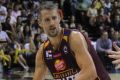 Brisbane forward Daniel Kickert looks to hand the ball off to teammate Jermaine Beal.