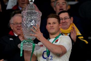 Dylan Hartley of England lifts the trophy after the final whistle.