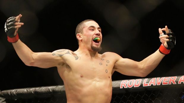 Robert Whittaker celebrates after defeating Derek Brunson.