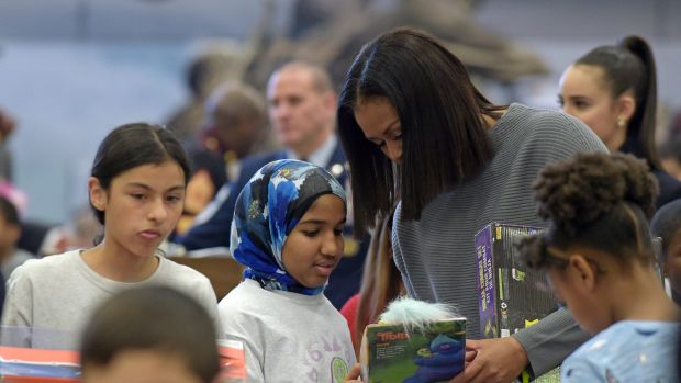 First lady Michelle Obama helps sort toys and gifts for the Marine Corps' Toys for Tots Campaign at Joint Base ...