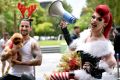 Tom Gough, left, with Poppy Maus the toy poodle, and drag queen Art Simone at the Chapel Street Christmas parade. 