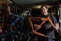 Cycle Surgery bicycle mechanic Simon Spoors in his workshop with broken bikes and parts. Some bikes aren't worth fixing, ...