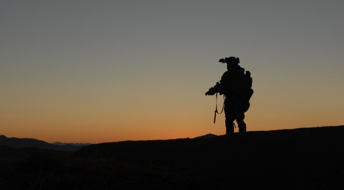 A U.S. Army Special Forces Soldier, with Special Operations Task Force  South, scans the horizon for enemy activity in Shah Wali Kot District, Kandahar Province, Afghanistan during a clearing operation Feb. 8, 2011 alongside Afghan Commandos from 2nd Company, 3rd Commando Kandak.  The commandos, along with District Chief of Police, Bacha Khan, detained 20 suspected insurgents for questioning.  The partnered units also found 80 pounds of homemade explosives and various improvised explosive device making components on the operation. (U.S. Army photo by Staff Sgt. Jeremy D. Crisp)(Released).