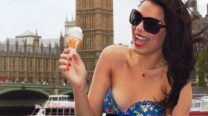 Woman eating ice-cream outside Big Ben, London