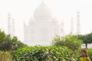 Girls work in the Mehtab Bagh (Moonlight Garden) in sight of the famous Taj Mahal palace.