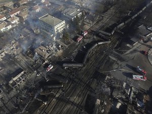 In this aerial view emergency services attend the scene of devastation after a tanker train derailed and a gas tank exploded in the village of Hitrino, northeastern Bulgaria