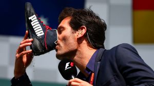 Webber drinks champagne from the boot of Daniel Ricciardo after the Belgium GP.