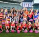 Daisy Pearce (far right) with fellow players and potential future stars at the launch of the league.