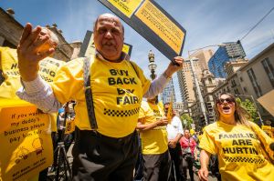 Taxi drivers vent their frustration at a rally on the steps of Parliament house on December 3, 2016 in Melbourne, Australia.