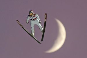 Jakub Janda of Czech Republic jumps in front of the rising moon.