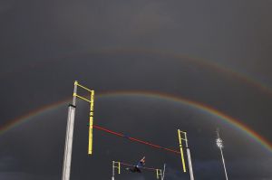 A rainbow appears as a male athlete competes in the Steve Hooker Pole Vault Challenge during the Zatopek 10 Australian ...