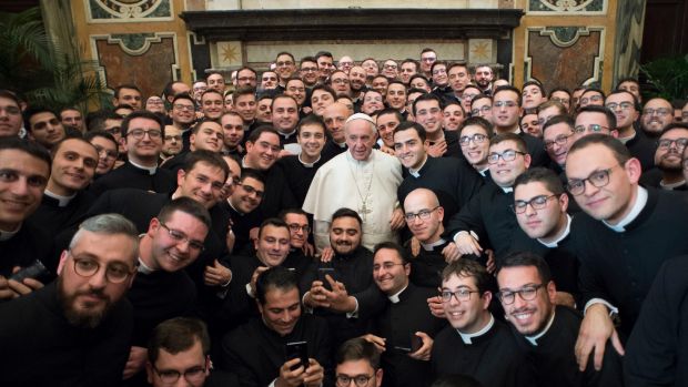 Pope Francis poses with members of the International Rural Catholic Association, at the Vatican Saturday, Dec. 10, 2016.