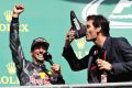 SPA, BELGIUM - AUGUST 28: Mark Webber drinks champagne from the boot of Daniel Ricciardo of Australia and Red Bull ...