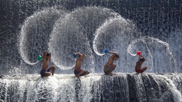 Boys playing in the Udam Dam River in Bali.