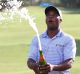 Spray it again: Harold Varner of the US celebrates after winning the Australian PGA Championship. 