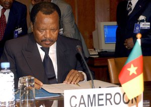 Cameroon's President Paul Biya studies documents during a meeting with Nigeria's President Olusegun Obasanjo and U.N. Secretary-General Kofi Annan, Friday, Nov. 15, 2002, at the UN headquarters in Geneva, Switzerland