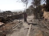 A resident of Halamish surveys the damage done to the West Bank settlement, November 26, 2016.