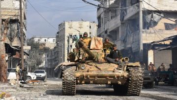 Syrian pro-government forces patrol Aleppo's eastern al-Salihin neighborhood after troops retook the area from rebel fighters, Syria, December 12, 2016.
