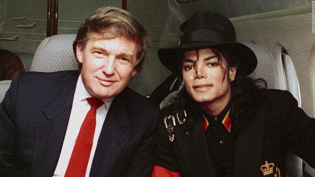 Trump and singer Michael Jackson pose for a photo before traveling to visit Ryan White, a young child with AIDS, in 1990.