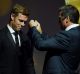 Former Hawthorn now West Coast player Sam Mitchell receives the 2012 Brownlow Medal from Shane Crawford on Tuesday. 