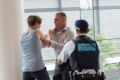 What not to do: a staged police image of a fight at an airport.