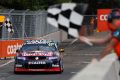 Shane van Gisbergen is shown the chequered flag during the Sydney 500 on Friday.