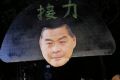 Pro-democracy protesters display a picture of Hong Kong chief Leung Chun-ying outside the Hong Kong Government House, as ...