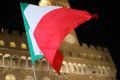 A 'Yes' campaign supporter waves the Italian national flag in Piazza della Signoria. Investors will be keeping an eye on ...