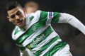 Celtic's Tom Rogic, left, and Barcelona's Lionel Messi challenge for the ball during the Champions League Group C soccer ...