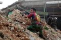 Syrian army soldiers fire their weapons during a battle with insurgents at the Ramouseh front line, east of Aleppo, Syria. 