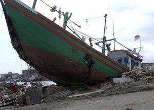 File Banda Aceh, Sumatra, Indonesia (Jan. 17, 2005)- The strength of the Tsunami that hit Banda Aceh is evident by the large boats it lifted and left on top of piles of debris when the waters receded.