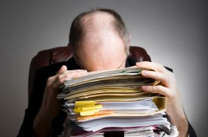 GENERIC - Series of an older businessman at desk. Stress in tray documents overworked tired.