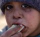 A Syrian boy displaced with his family from eastern Aleppo eats a vegetable in the village of Jibreen south of the city ...