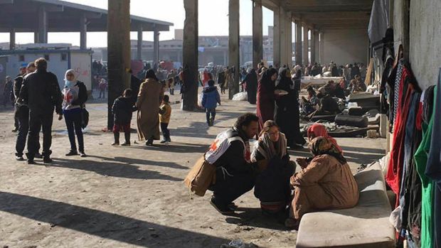 Syrians who were displaced with their families from eastern Aleppo gather at the collective shelter, in the village of ...