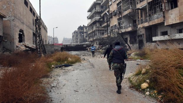 Syrian troops and pro-government gunmen marching through the streets of east Aleppo on Tuesday.