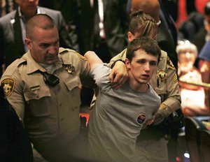 Michael Sandford as Republican presidential candidate Donald Trump speaks at the Treasure Island hotel and casino in Las Vegas. The mother of Standford who is accused of attempting to shoot Donald Trump told British television he will plead guilty to lesser charges in a U.S. court.