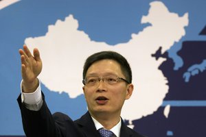 Taiwan Affairs Office spokesman An Fengshan signals for questions from a journalist at a routine press conference in Beijing, China, Wednesday, Dec. 14, 2016.