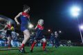 Daisy Pearce of the Demons leads the team out during this year's AFL women's exhibition match at Whitten Oval.