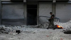 Free Syrian Army soldier walking among rubble in Aleppo