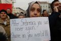 A Bosnian woman holds a banner during an Aleppo solidarity rally in Sarajevo on Wednesday.